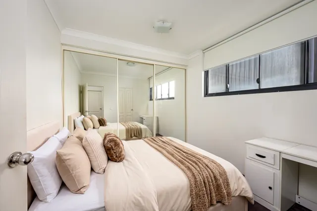 Bedroom with mirrored built-in wardrobe